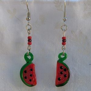 Handmade glass watermelon slice earrings with pink-red centers, green rinds, and sterling silver hooks.