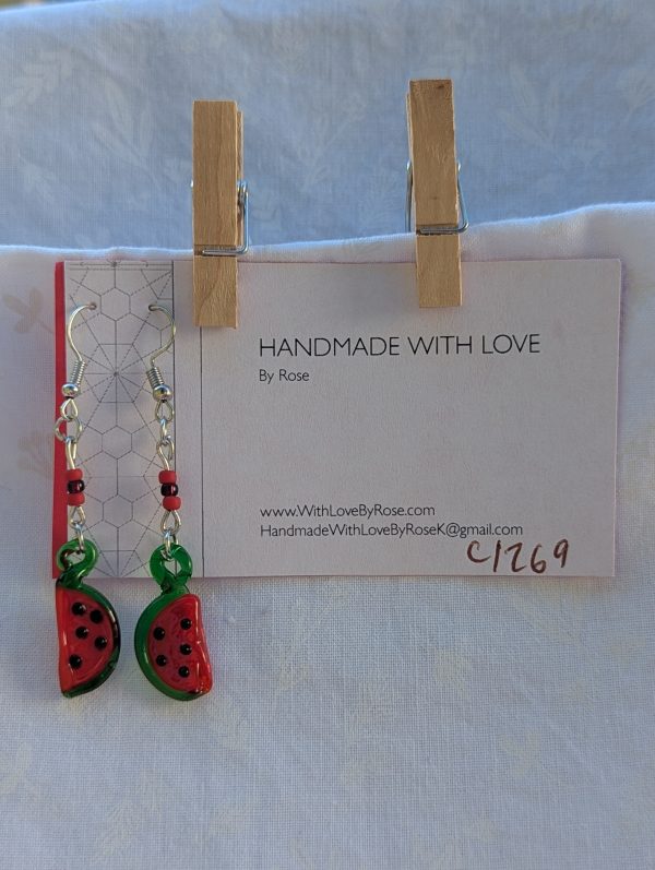 Handmade glass watermelon slice earrings with pink-red centers, green rinds, and sterling silver hooks.