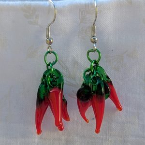 Handmade chili pepper earrings with four red glass peppers linked by green aluminum rings and hung from steel French hooks.