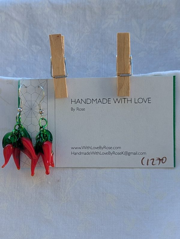 Handmade chili pepper earrings with four red glass peppers linked by green aluminum rings and hung from steel French hooks.