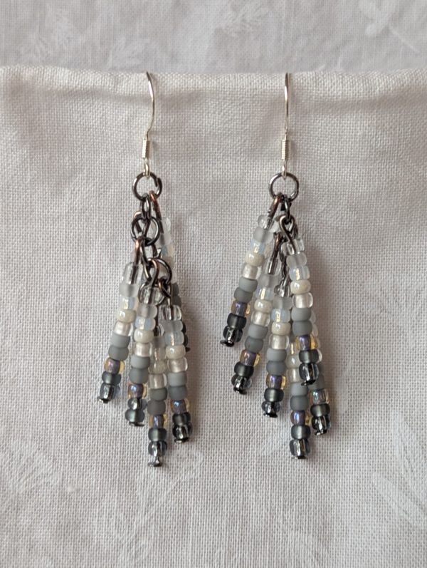 Handmade gradient beaded earrings with black-to-white ombre seed beads, tungsten connectors, and sterling silver hooks.