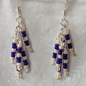 Handmade blue and cream beaded earrings with silver connectors and sterling silver hooks, featuring cascading strands of seed beads.