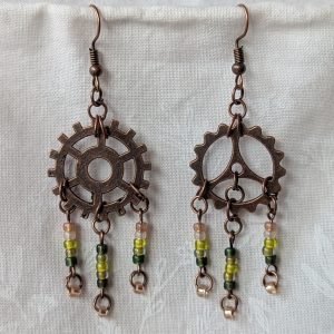 Handmade bronze gear steampunk earrings with green and brown glass beads, asymmetrical steampunk design, and antique bronze hooks.