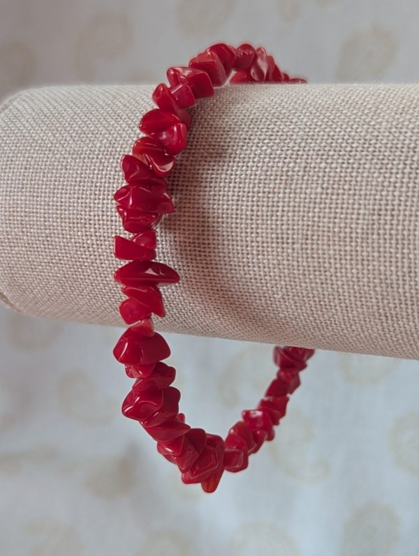 Red stone memory wire bracelet with polished cherry red chip stone beads and a silver-colored lobster clasp closure.