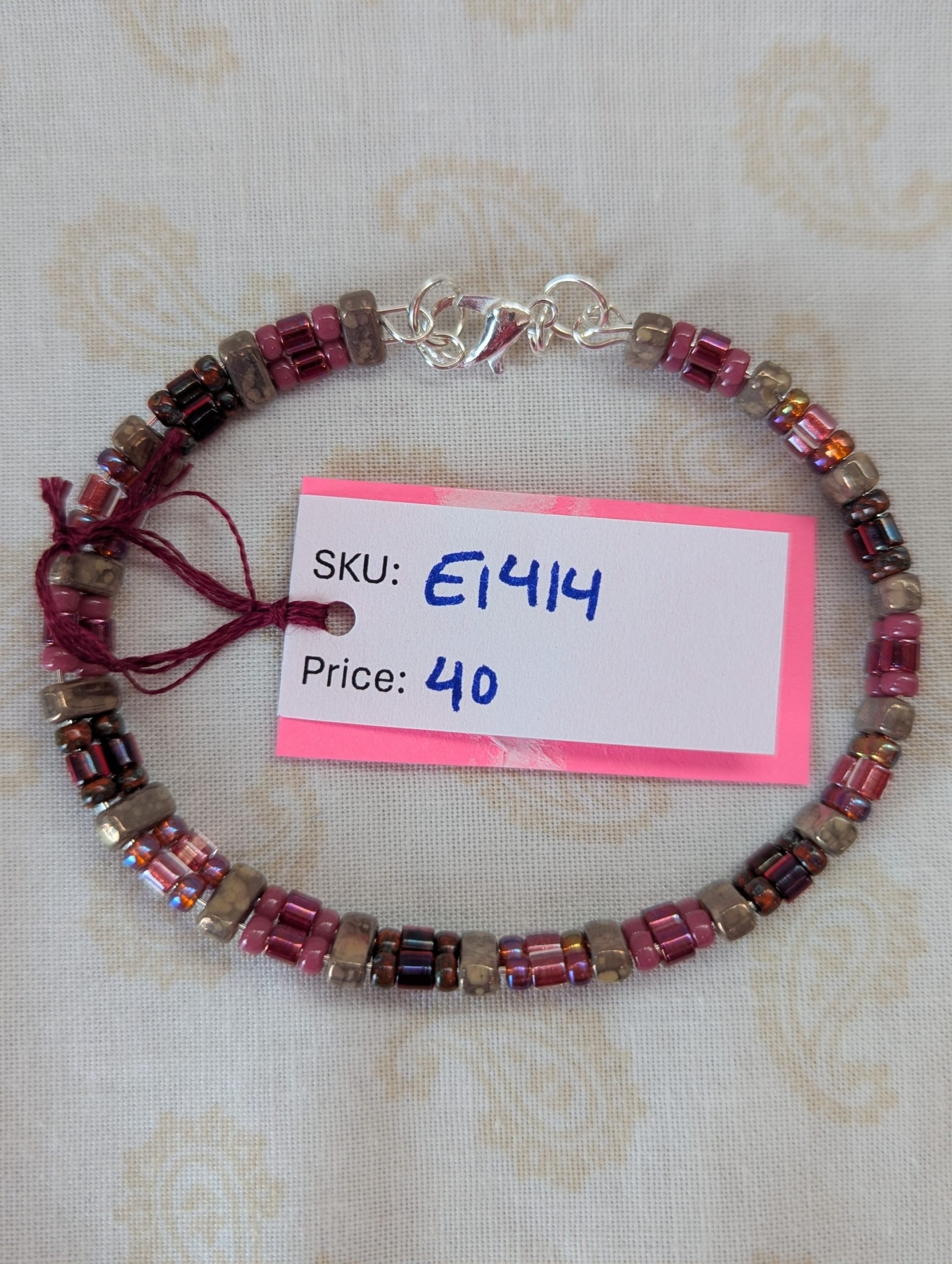 Double-strand memory wire bracelet with rose mauve, garnet, and taupe rectangular stone beads, finished with a silver lobster clasp.