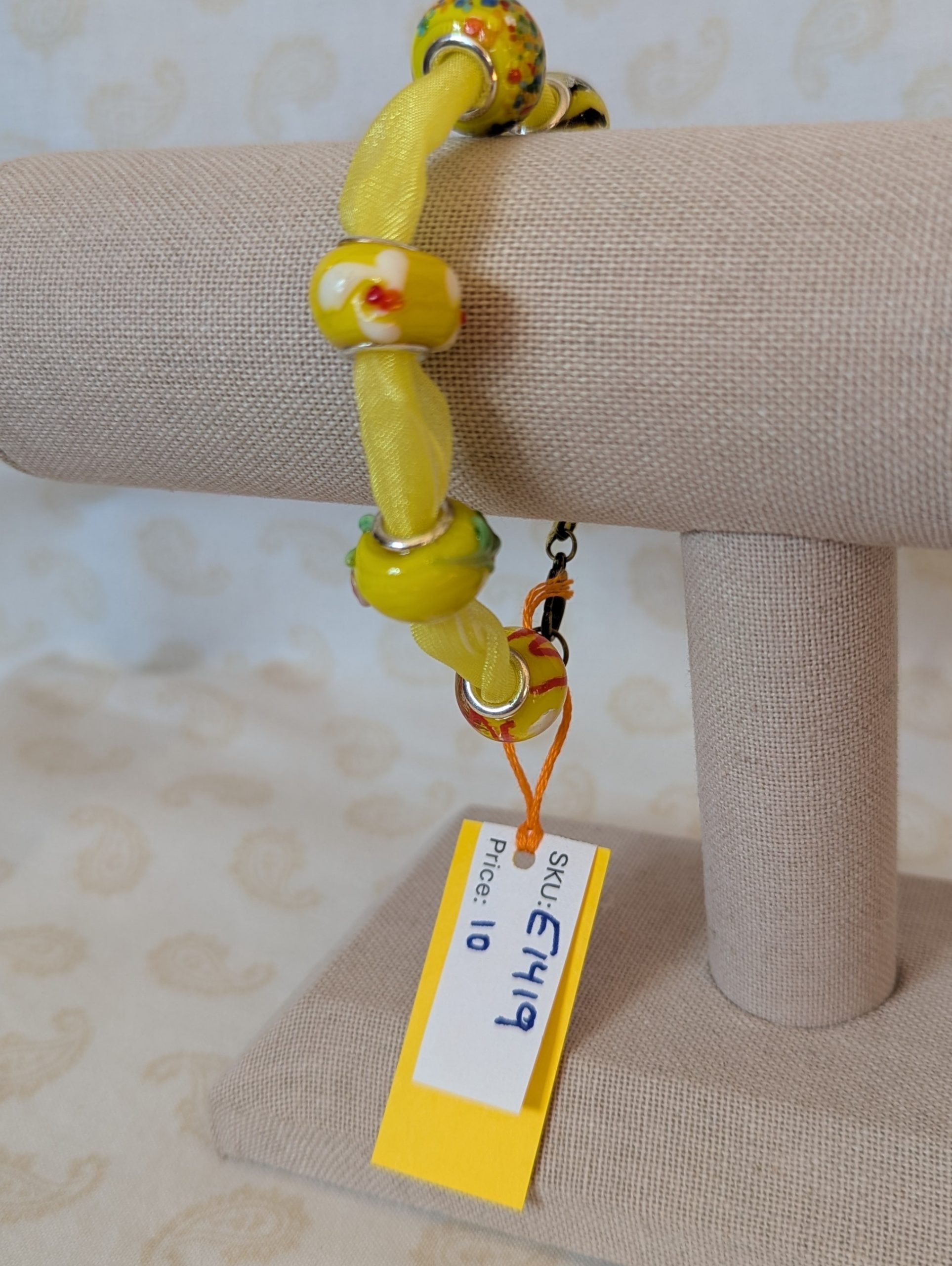 Sunshine Yellow Lampwork and Ribbon Bracelet: six yellow lampwork-style glass beads on a bright yellow ribbon with a lobster clasp closure