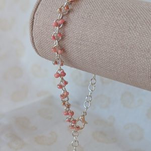 Blush and Petal Pink Beaded Chain Bracelet: a silver chain bracelet with pale pink seed beads in solid blush, pink-lined clear, and pearly iridescent finishes, secured with a lobster clasp.