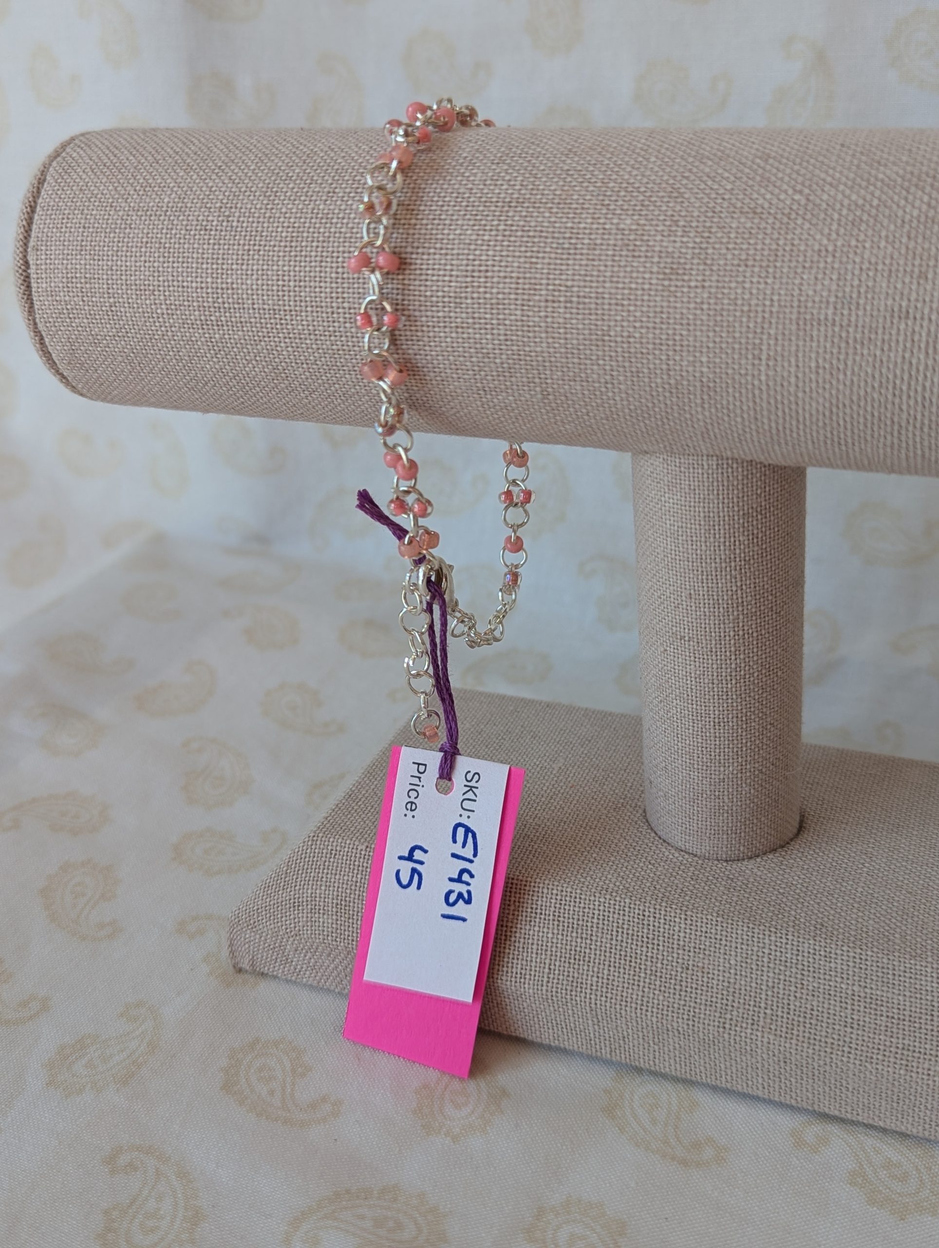 Blush and Petal Pink Beaded Chain Bracelet: a silver chain bracelet with pale pink seed beads in solid blush, pink-lined clear, and pearly iridescent finishes, secured with a lobster clasp.