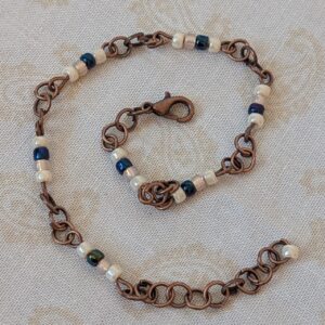 Bronze chain bracelet with cream and indigo blue glass seed beads and lobster clasp