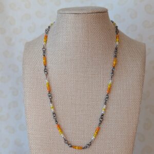 Tungsten-toned chain necklace with gradient orange, yellow, and white glass seed beads and lobster clasp