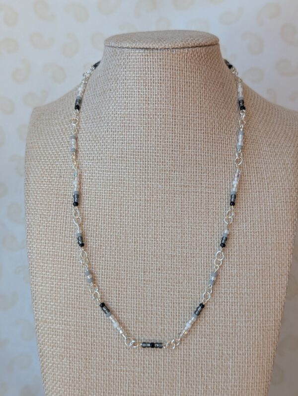 Silver chain necklace with black, gray, and white gradient glass seed beads and lobster clasp